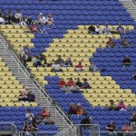 
              Spectators sit in the grandstands to watch qualifying for Saturday's Sprint Cup Series auto race at Kansas Speedway in Kansas City, Kan., Friday, May 8, 2015. (AP Photo/Orlin Wagner)
            