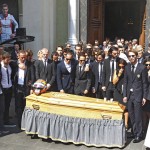 
              Formula one drivers and family members stand in front of the casket of French Formula One driver Jules Bianchi into Sainte Reparate Cathedral during his funeral in Nice, French Riviera, Tuesday, July 21, 2015. Bianchi, 25, died Friday from head injuries sustained in a crash at last year's Japanese Grand Prix. He had been in a coma since the Oct. 5 accident, in which he collided at high speed with a mobile crane which was being used to pick up another crashed car. (AP Photo/Lionel Cironneau)
            