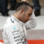 
              Mercedes driver Lewis Hamilton of Britain, third placed, touches his head at the end of the Formula One Grand Prix, at the Monaco racetrack, in Monaco, Sunday, May 24, 2015. Nico Rosberg won the Monaco Grand Prix for the third straight year after a late crash involving teenager Max Verstappen undid Lewis Hamilton's bid for a fourth win of the season. (AP Photo/Luca Bruno)
            