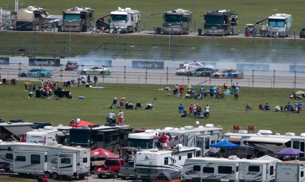 Fans watch a multi-car crash on the back straight during the Talladega 500 NASCAR Sprint Cup Series...