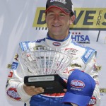
              A.J. Allmendinger poses with his award after winning the pole position while qualifying for the NASCAR Sprint Cup Series auto race Saturday, June 27, 2015, in Sonoma, Calif. (AP Photo/Eric Risberg)
            
