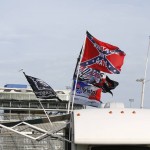 
              Races fans fly Confederate flags in the infield during a NASCAR Sprint Cup practice session at Daytona International Speedway, Friday, July 3, 2015, in Daytona Beach, Fla. (AP Photo/Terry Renna)
            