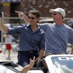 
              NASCAR driver Jeff Gordon, left, waves to fans along the parade route in Pittsboro, Ind., Thursday, July 23, 2015. Pittsboro, had a parade for Gordon as part of his  farewell tour.  Gordon will drive in Sunday's Brickyard 400.  (AP Photo/Michael Conroy)
            