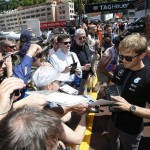 
              Mercedes driver Nico Rosberg of Germany signs autographs in the pit lane at the Monaco racetrack, in Monaco, Friday, May 22, 2015. The Formula one race will be held on Sunday. (AP Photo/Claude Paris)
            
