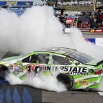 
              Kyle Busch burns out after winning the NASCAR Sprint Cup series auto race at New Hampshire Motor Speedway Sunday, July 19, 2015, in Loudon, N.H. (AP Photo/Jim Cole)
            