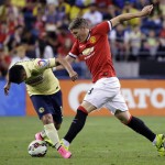 
              Manchester United's Bastian Schweinsteiger, right, challenges Club America's Osvaldo Martinez during the second half of an international friendly soccer match, Friday, July 17, 2015, in Seattle. (AP Photo/Ted S. Warren)
            