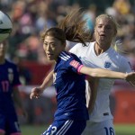 
              England's Katie Chapman (16) and Japan's Rumi Utsugi (13) vie for the ball during the second half of a semifinal in the FIFA Women's World Cup soccer tournament, Wednesday, July 1, 2015, in Edmonton, Alberta, Canada. Japan won 2-1. (Jason Franson/The Canadian Press via AP)
            
