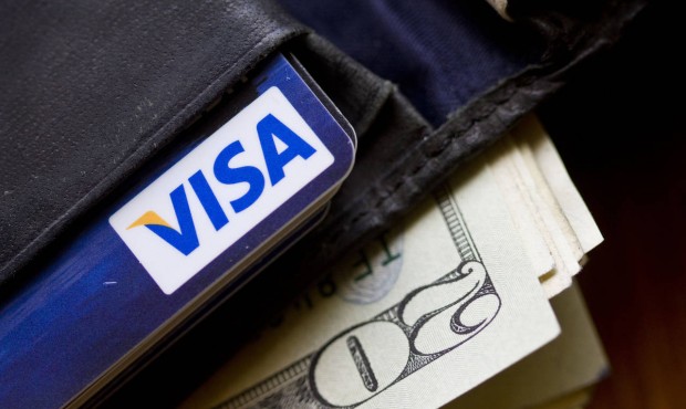 FILE – This Feb. 2, 2011 file photo shows a wallet containing cash and a Visa card in Surfsid...