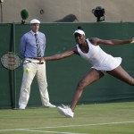 
              Venus Williams of the United States returns a shot to Yulia Putintseva of Kazakhstan  during their singles match at the All England Lawn Tennis Championships in Wimbledon, London, Wednesday July 1, 2015. (AP Photo/Pavel Golovkin)
            