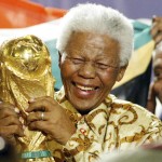 
              FILE - In this May 15, 2004 file photo, former South African President Nelson Mandela lifts the World Cup trophy in Zurich, Switzerland, after FIFA's executive committee announced that South Africa would host the 2010 FIFA World Cup soccer tournament. FIFA has been routinely called “scandal-plagued” for much of Sepp Blatter’s 17-year presidential reign. The first two World Cup hosting votes in Blatter’s presidency were marked by intrigue and bribe allegations, including the South African bid which defeated Morocco to get the 2010 World Cup. (AP Photo/Michael Probst, File)
            