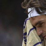 
              Roger Federer of Switzerland wipes his face with a towel during the men's singles final against Novak Djokovic of Serbia at the All England Lawn Tennis Championships in Wimbledon, London, Sunday July 12, 2015. (Toby Melville/Pool Photo via AP)
            
