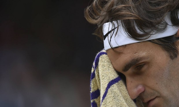 Roger Federer of Switzerland wipes his face with a towel during the men’s singles final again...