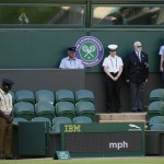 
              People observe the minute silence for the victims of the shooting in Tunisia last week, at the All England Lawn Tennis Championships in Wimbledon, London, Friday July 3, 2015. Fans and staff at Wimbledon observed a minute’s silence for the victims of last Friday’s attack in Tunisia, in which 30 Britons were killed in a shooting rampage at a beach resort in Sousse.  The start of play at Wimbledon was delayed so the tournament could join in the national minute’s silence. (AP Photo/Kirsty Wigglesworth)
            