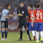 
              FILE - In this  June 24, 2015, file photo, Uruguay's Edinson Cavani  protests to referee Sandro Ricci, from Brazil, as he is being sent off with a red card after two yellow cards during a Copa America quarterfinal soccer match against Chile at the National Stadium in Santiago, Chile. Although some might think that in this case Cavani's complaint was justified, most agree that South American players are known for their vivid complaints and have long enjoyed more leeway when interacting with referees, especially compared to leagues in Europe, and now Brazil wants to put an end to that. (AP Photo/Jorge Saenz, File)
            
