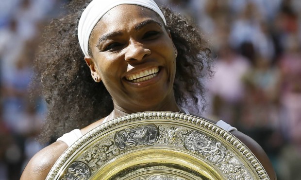 Serena Williams of the United States holds the trophy after winning the women’s singles final...