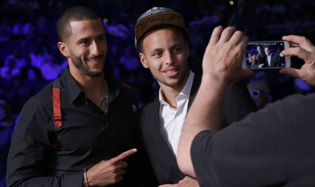 San Francisco 49ers quarterback Colin Kaepernick, left, poses for photos with Golden State Warriors...
