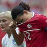 
              Canada's Christine Sinclair, right, reacts to a missed shot as England's Katie Chapman looks on during the first half of a FIFA Women's World Cup quarterfinal soccer game in Vancouver, British Columbia, Canada, on Saturday, June 27, 2015. (Jonathan Hayward/The Canadian Press via AP) MANDATORY CREDIT
            