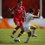 
              Canada's Christine Sinclair, left, tries to get past China's Wu Haiyan during FIFA Women's World Cup soccer game action in Edmonton, Alberta, Saturday, June 6, 2015. (Jeff McIntosh/The Canadian Press via AP) MANDATORY CREDIT
            