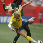 
              Sweden's Sofia Jakobsson (10) knocked off the ball by Nigeria's Asisat Oshoala (8) during the first half of a FIFA Women's World Cup soccer match in Winnipeg, Manitoba, Monday, June 8, 2015. (John Woods/The Canadian Press via AP) MANDATORY CREDIT
            