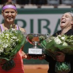 
              Bethanie Mattek-Sands of the U.S., right, and   Lucie Safarova of the Czech Republic, left, hold the trophy after winning the women's doubles final of the French Open tennis tournament in three sets, 3-6, 6-4, 6-2, against Casey Dellacqua of Australia and Yaroslava Shvedova of Kazakhstan at the Roland Garros stadium, in Paris, France, Sunday, June 7, 2015. (AP Photo/Thibault Camus)
            