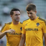 
              Los Angeles Galaxy's Steven Gerrard, right, of England, and Robbie Keane, of Ireland, walk on the pitch before the Galaxy's MLS soccer match against the San Jose Earthquakes, Friday, July 17, 2015, in Carson, Calif. (AP Photo/Jae C. Hong)
            