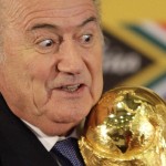
              FILE - In this Sunday June 6, 2010 file photo FIFA President Joseph Blatter holds the trophy after receiving it back from South African President Jacob Zuma during a media briefing on the 2010 Soccer World Cup in Pretoria, South Africa.  FIFA President Sepp Blatter will resign from soccer's governing body amid a widening corruption scandal and promised Tuesday to call for fresh elections to choose a successor. (AP Photo/Themba Hadebe, File)
            