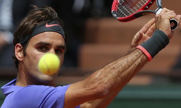 Switzerland’s Roger Federer eyes the ball as he plays France’s Gael Monfils during thei...