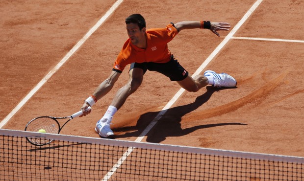Serbia’s Novak Djokovic returns the ball to Britain’s Andy Murray during their semifina...