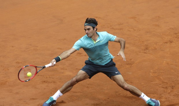 FILE – In this May 15, 2015, file photo, Roger Federer, of Switzerland, returns the ball to T...