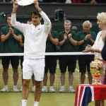 
              Roger Federer of Switzerland holds up the runner up trophy up after being defeated by Novak Djokovic of Serbia in the men's singles final at the All England Lawn Tennis Championships in Wimbledon, London, Sunday July 12, 2015. Djokovic won the match 7-6, 6-7, 6-4, 6-3. (AP Photo/Alastair Grant)
            