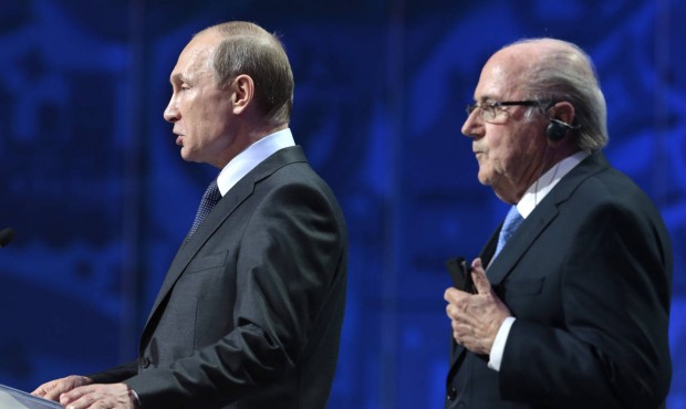 Russian President Vladimir Putin, left, and FIFA President Sepp Blatter open the preliminary draw f...