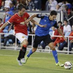 
              Manchester United defender Matteo Darmian, left, and San Jose Earthquakes midfielder Shea Salinas race for the ball during the first half of an International Champions Cup soccer match Tuesday, July 21, 2015, in San Jose, Calif. (AP Photo/Eric Risberg)
            