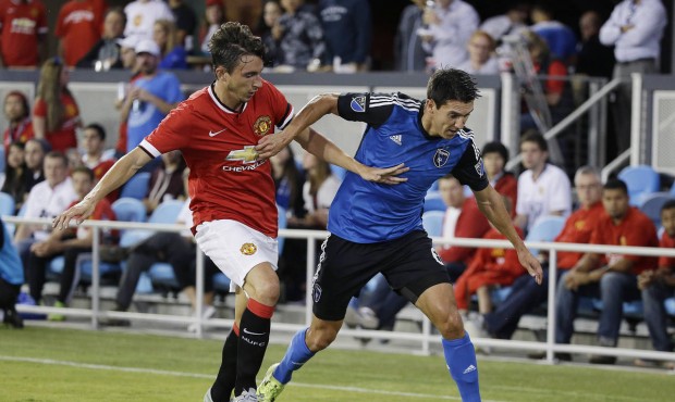 Manchester United defender Matteo Darmian, left, and San Jose Earthquakes midfielder Shea Salinas r...