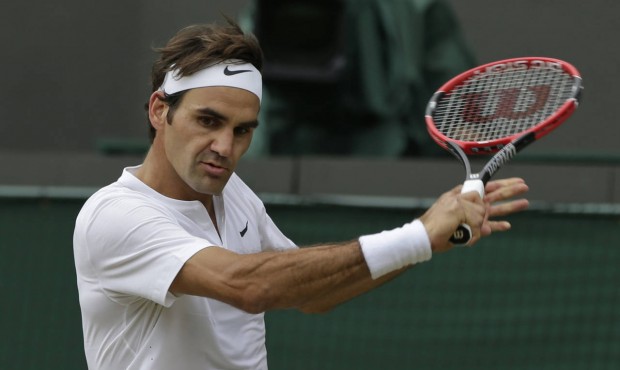 Roger Federer of Switzerland plays a return to Gilles Simon of France during the men’s quarte...
