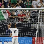 
              Mexico midfielder Andres Guardado grabs the goal net in frustration after missing a scoring chance against Guatemala during the first half of a CONCACAF Gold Cup soccer match Sunday, July 12, 2015, in Glendale, Ariz. (AP Photo/Ross D. Franklin)
            