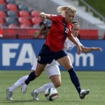 
              Norway's Ada Hegerberg, left, shields the ball from England's Lucy Bronze during the first half of a second round soccer game at the FIFA Women's World Cup, Monday, June 22, 2015, in Ottawa, Ontario, Canada. (Adrian Wyld/The Canadian Press via AP) MANDATORY CREDIT
            