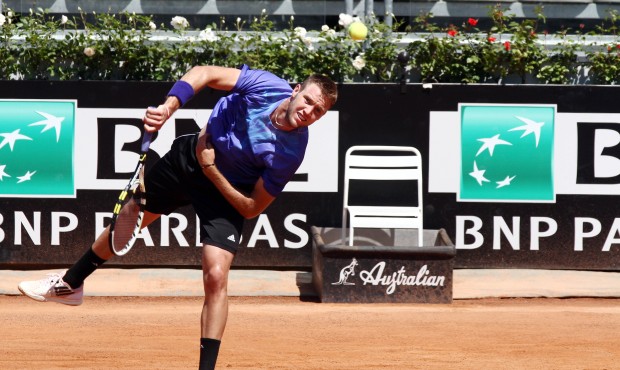Jack Sock from US serves the ball to France’s Gilles Simon during their match at the Italian ...