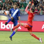 
              Mexico goal keeper Guillermo Ochoa, right, comes out to alter the shot of Guatemala forward Minor Lopez (22) during the first half of a CONCACAF Gold Cup soccer match Sunday, July 12, 2015, in Glendale, Ariz. (AP Photo/Ross D. Franklin)
            