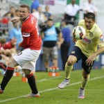 
              Manchester United's Wayne Rooney, left, looks back asClub America's Pablo Cesar Aguilar moves the ball during the first half of an international friendly soccer match, Friday, July 17, 2015, in Seattle. (AP Photo/Ted S. Warren)
            