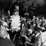 
              FILE- In this June 10, 1978, file photo, jockey Steve Cauthen raises his arm in a victory salute after riding Affirmed to win the Belmont Stakes, and thereby capturing the Triple Crown, at Belmont Park in New York. On Saturday, American Pharoah will take on seven rivals in the Belmont in his bid to end a 37-year Triple Crown drought. (AP Photo/File)
            