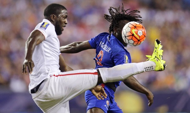 Haiti’s Reginal Goreux, right, tries to head the ball away as he is challenged by United Stat...