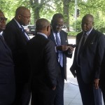 
              FIFA senior Vice President Issa Hayatou of Cameroon, third right,  checks his phone outside an hotel in Zurich, Switzerland, Wednesday morning, May 27, 2015. The Swiss Federal Office of Justice said six soccer officials have been arrested and detained pending extradition at  the request of U.S. authorities ahead of the FIFA congress in Zurich. In a statement Wednesday the FOJ said U.S. authorities suspect the officials of having received paid bribes totaling millions of dollars. Swiss federal prosecutors also announced that they were to open criminal proceedings related to the 2018 and 2022 World Cups. (AP Photo/Graham Dunbar)
            