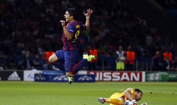 Barcelona’s Luis Suarez jumps over Juventus goalkeeper Gianluigi Buffon during the Champions ...