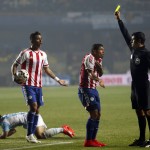 
              FILE - In this  June 30, 2015, file photo, referee Sandro Ricci, from Brazil, shows a yellow card to Paraguay's Richard Ortiz after he fouled Argentina's Sergio Aguero, right, during a Copa America semifinal soccer match at the Ester Roa Rebolledo Stadium in Concepcion, Chile. South American players are known for their vivid complaints and have long enjoyed more leeway when interacting with referees, especially compared to leagues in Europe, and now Brazil wants to put an end to that. (AP Photo/Silvia Izquierdo,File)
            