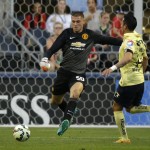 
              Manchester United goalkeeper Sam Johnstone, left, kicks the ball away as Club America's Rubens Sambueza moves in during the first half of an international friendly soccer match, Friday, July 17, 2015, in Seattle. (AP Photo/Ted S. Warren)
            