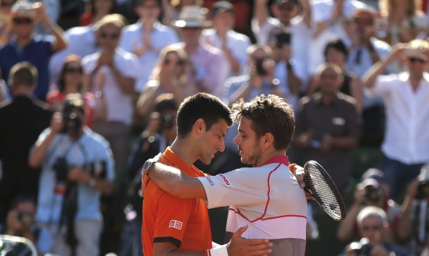 Switzerland’s Stan Wawrinka, right, hugs Serbia’s Novak Djokovic after their final matc...