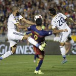 
              FC Barcelona's Luis Suarez, center, is defended by Los Angeles Galaxy's Leonardo, left, and A.J. DeLaGarza during the first half of an International Champions Cup soccer match, Tuesday, July 21, 2015, in Pasadena, Calif. (AP Photo/Jae C. Hong)
            
