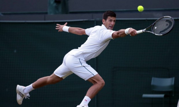 n Novak Djokovic of Serbia returns a ball to Kevin Anderson of South Africa during their singles ma...