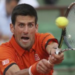 
              Serbia's Novak Djokovic returns in the semifinal match of the French Open tennis tournament against Britain's Andy Murray at the Roland Garros stadium, in Paris, France, Friday, June 5, 2015. (AP Photo/David Vincent)
            