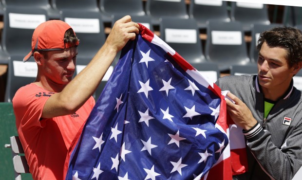 Tommy Paul of the U.S., left, holds the American after winning the boys final match of the French O...